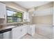 Bright kitchen featuring granite countertops, stainless steel appliances, and white cabinetry at 5 Pine Run, Haines City, FL 33844