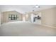 Bright, open living room features vaulted ceiling, neutral walls, and view into the adjacent kitchen at 5 Pine Run, Haines City, FL 33844