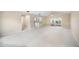 Bright and airy living room with plush carpeting, neutral walls, and open access to the kitchen at 5 Pine Run, Haines City, FL 33844