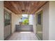 Covered side entrance featuring tiled floors and a flood barrier, providing secure access to the home at 5 Pine Run, Haines City, FL 33844