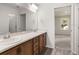 Bathroom features a double sink vanity with wood cabinets and a large mirror at 5317 Se 127Th Ln, Belleview, FL 34420
