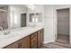 Bathroom featuring double sinks, wood cabinets, and a glass-enclosed shower at 5317 Se 127Th Ln, Belleview, FL 34420