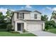 Charming two-story home with gray shingles, white siding, and manicured landscaping at 5317 Se 127Th Ln, Belleview, FL 34420