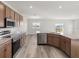Modern kitchen featuring stainless steel appliances and a breakfast bar overlooking the living area at 5317 Se 127Th Ln, Belleview, FL 34420