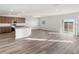 Spacious open-concept living room features wood-look floors and sliding glass doors at 5317 Se 127Th Ln, Belleview, FL 34420