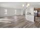 Bright living room area featuring modern chandelier lighting, hardwood flooring, and neutral color scheme at 5317 Se 127Th Ln, Belleview, FL 34420