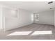 Open loft area with carpet flooring, natural lighting, and a neutral color scheme at 5317 Se 127Th Ln, Belleview, FL 34420