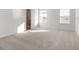 Bright and airy primary bedroom boasts plush carpeting and plenty of natural light at 5317 Se 127Th Ln, Belleview, FL 34420