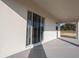 View of patio with large sliding glass doors and a view of a green field at 5317 Se 127Th Ln, Belleview, FL 34420