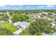 Expansive aerial view of a charming single Gathering home with a well-maintained yard, mature trees, and two-car garage at 535 N Todhunter Way, Lake Alfred, FL 33850