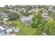 Aerial view showing the backyard pool and various outbuildings, including the home's layout and surrounding greenery at 535 N Todhunter Way, Lake Alfred, FL 33850