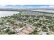Picturesque aerial view showcasing residential homes near the scenic lake, nestled among lush trees within the community at 535 N Todhunter Way, Lake Alfred, FL 33850