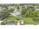 This aerial shows the pool, patio, and fenced yard in addition to the structure of the roof and surrounding landscape at 535 N Todhunter Way, Lake Alfred, FL 33850