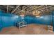 Finished basement with three chandeliers, blue accent walls and wood-look floors at 535 N Todhunter Way, Lake Alfred, FL 33850