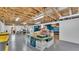 Large basement with exposed ceiling, concrete floor, shelving and workspaces at 535 N Todhunter Way, Lake Alfred, FL 33850
