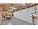 Large basement area with pool table, exposed ceiling and ample space for storage or activities at 535 N Todhunter Way, Lake Alfred, FL 33850
