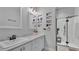 Bathroom featuring a modern vanity with sleek fixtures, recessed shelving, and a glass-enclosed shower at 535 N Todhunter Way, Lake Alfred, FL 33850