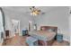 Bedroom with ceiling fan, ensuite bathroom and walk-in closet at 535 N Todhunter Way, Lake Alfred, FL 33850