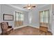 Bright bedroom featuring wood-look flooring, ceiling fan, and neutral walls at 535 N Todhunter Way, Lake Alfred, FL 33850