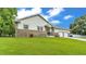 Single story home with beautiful stone accents, lush green lawn, and well-maintained landscaping at 535 N Todhunter Way, Lake Alfred, FL 33850