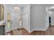 Inviting home foyer with hardwood floors, modern light fixture, and coat closet at 535 N Todhunter Way, Lake Alfred, FL 33850