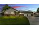 Inviting single-Gathering home with well-kept lawn, gray siding, stone accents, and a spacious two-car garage at 535 N Todhunter Way, Lake Alfred, FL 33850