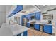 Stylish blue kitchen featuring quartz countertops, stainless steel appliances, and ample cabinet space at 535 N Todhunter Way, Lake Alfred, FL 33850