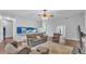 Spacious open floor plan showing the living room flowing into the bright blue kitchen at 535 N Todhunter Way, Lake Alfred, FL 33850