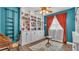 Home library with built-in bookshelves, complemented by a ceiling fan and natural light from the window at 535 N Todhunter Way, Lake Alfred, FL 33850