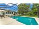 Tranquil screened-in pool with sparkling clear water, patio furniture, and well-maintained backyard at 535 N Todhunter Way, Lake Alfred, FL 33850