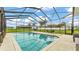 Inviting pool with a screened-in enclosure, showcasing clear water and an outdoor dining set for entertaining at 535 N Todhunter Way, Lake Alfred, FL 33850