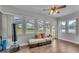 Bright sunroom with windows, wood-look floors and comfortable seating at 535 N Todhunter Way, Lake Alfred, FL 33850