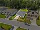 Aerial view of a well-kept home with a landscaped lawn, a driveway, and a backyard at 546 Scott Lake Creek Ln, Lakeland, FL 33813