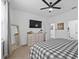 Bright bedroom boasts a comfortable queen bed, dresser, and a wall-mounted TV at 546 Scott Lake Creek Ln, Lakeland, FL 33813