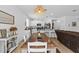 Dining room area boasts a rustic wooden table with white chairs and modern decor at 546 Scott Lake Creek Ln, Lakeland, FL 33813