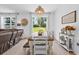 Cozy dining area with natural lighting and a farmhouse-style wooden table that is perfect for Gathering meals at 546 Scott Lake Creek Ln, Lakeland, FL 33813