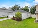 Charming single-story home featuring a well-maintained lawn, a one-car garage, and landscaped garden beds at 546 Scott Lake Creek Ln, Lakeland, FL 33813