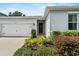 A well-maintained home featuring a one-car garage, complemented by colorful landscaping at 546 Scott Lake Creek Ln, Lakeland, FL 33813
