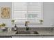 Close up of a granite countertop with a stainless steel sink and modern faucet fixture at 546 Scott Lake Creek Ln, Lakeland, FL 33813