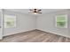 Bedroom featuring a ceiling fan and two windows for ample natural light at 6 Rosewood Dr, Davenport, FL 33837
