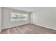 Bright bedroom with wood-look floors, large window, and ample closet space at 6 Rosewood Dr, Davenport, FL 33837