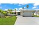 Charming single-story home featuring a well-manicured lawn, inviting entrance, and a convenient attached garage at 6 Rosewood Dr, Davenport, FL 33837