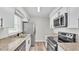 Charming kitchen featuring granite counters, stainless steel appliances and white shaker cabinets at 6 Rosewood Dr, Davenport, FL 33837