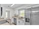 Well-lit kitchen featuring stainless steel appliances, granite countertops, and white cabinetry at 6 Rosewood Dr, Davenport, FL 33837