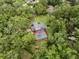 Stunning aerial view of a backyard featuring a beautiful pool and lush greenery at 6001 Sweet Gum Run, Bartow, FL 33830
