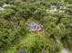 Aerial view of estate home surrounded by mature trees and a pool at 6001 Sweet Gum Run, Bartow, FL 33830