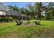 Backyard with sitting area, fire pit, and enclosed pool in the background at 6001 Sweet Gum Run, Bartow, FL 33830