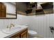Powder room featuring a white vanity, brass fixtures, and industrial-style shelving at 6001 Sweet Gum Run, Bartow, FL 33830