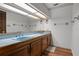 Bathroom with a double sink vanity, blue tile counters, and retro fixtures at 6001 Sweet Gum Run, Bartow, FL 33830