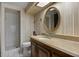 Cozy bathroom with a vintage vanity, wallpaper, and a walk-in shower at 6001 Sweet Gum Run, Bartow, FL 33830